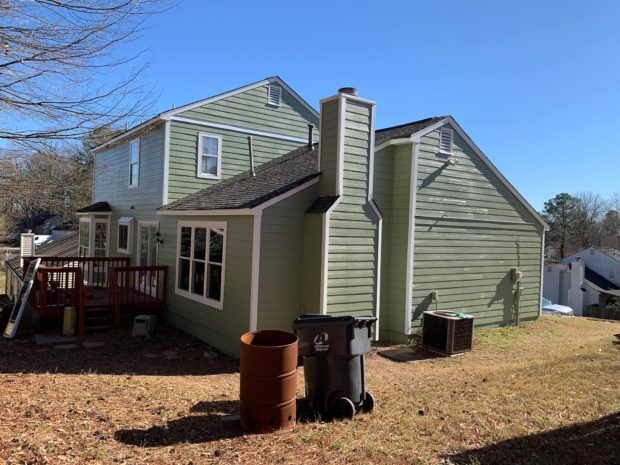 Side of Green House with Chimney with Siding Replacement and Siding Installation in Marietta