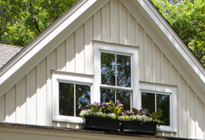 Picture windows on second story of a white home